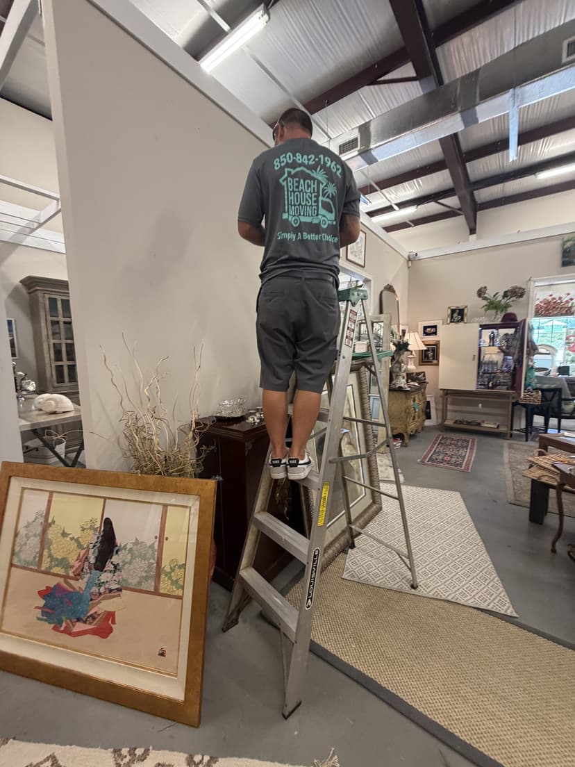 Framed fine art and antiques being placed and installed by Beach House Moving during a white-glove move on 30A
