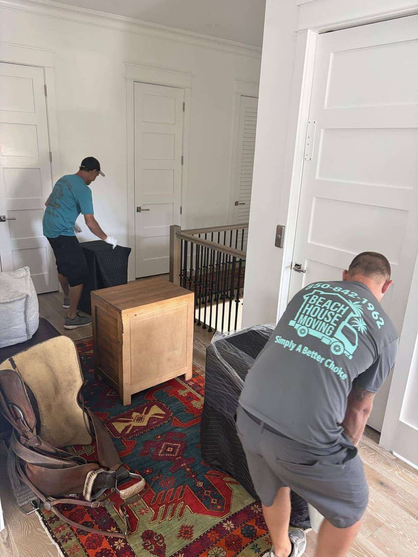 The Beach House Moving owner-operator team handling a customer move together
