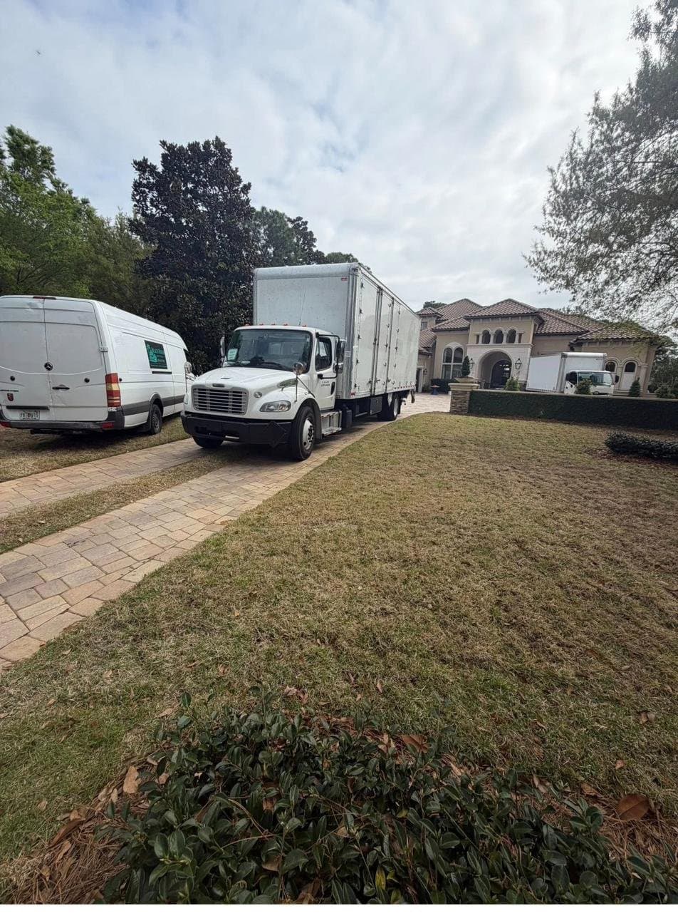 Beach House Moving box trucks and van at a luxury Emerald Coast estate